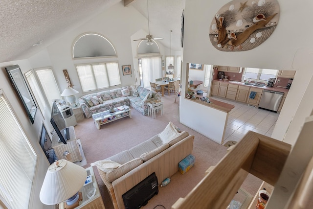 138 8th St, Avalon, NJ 08202 - living area featuring light colored carpet, high vaulted ceiling, ceiling fan, a textured ceiling, and beam ceiling
