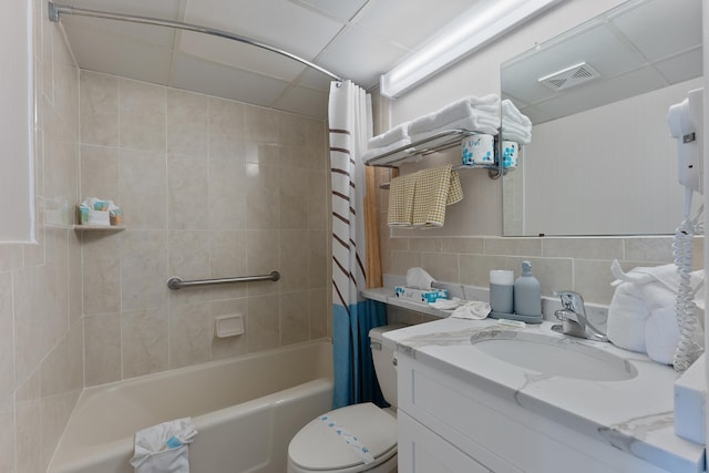 bathroom featuring shower / bath combo with shower curtain, vanity, toilet, tile walls, and backsplash