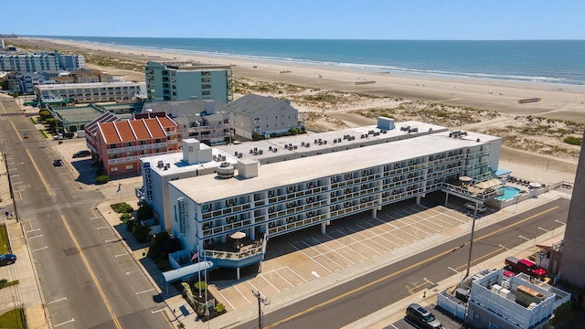 bird's eye view of expansive beach and apartment complex