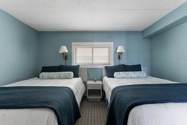 bedroom featuring a textured wall and carpet flooring