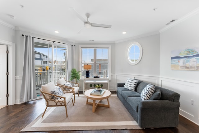 living room featuring crown molding, ceiling fan, and dark wood-type flooring