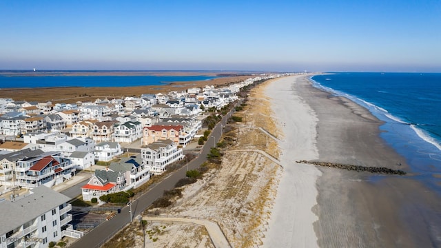 birds eye view of property featuring a water view and a view of the beach