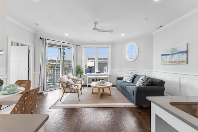 living room with ceiling fan, dark wood-type flooring, and ornamental molding