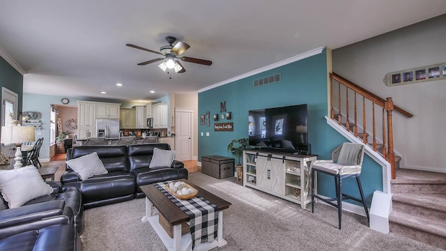 living room featuring light carpet, ceiling fan, and ornamental molding