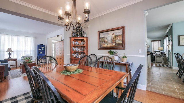 dining room featuring crown molding, hardwood / wood-style flooring, and a notable chandelier