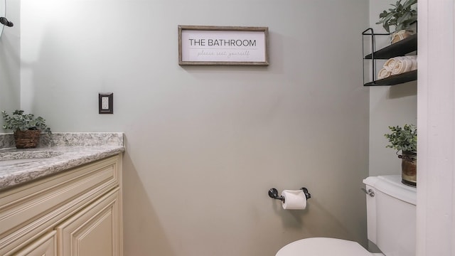 bathroom with toilet and vanity