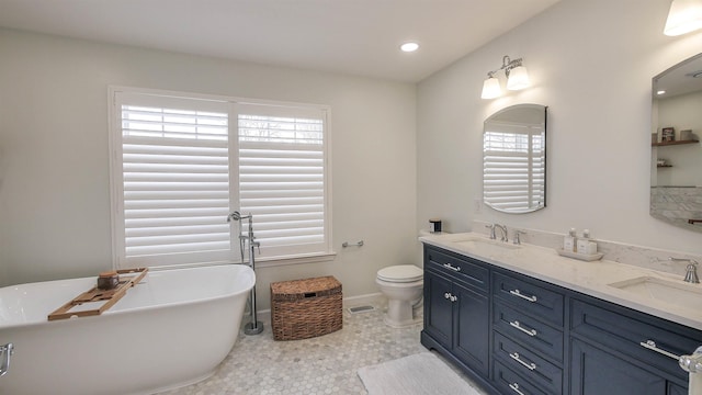 bathroom with vanity, tile patterned flooring, a washtub, and a healthy amount of sunlight