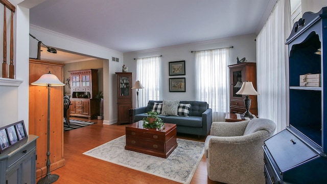 living room featuring ornamental molding and hardwood / wood-style flooring