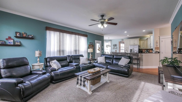 living room featuring ceiling fan, light colored carpet, and ornamental molding