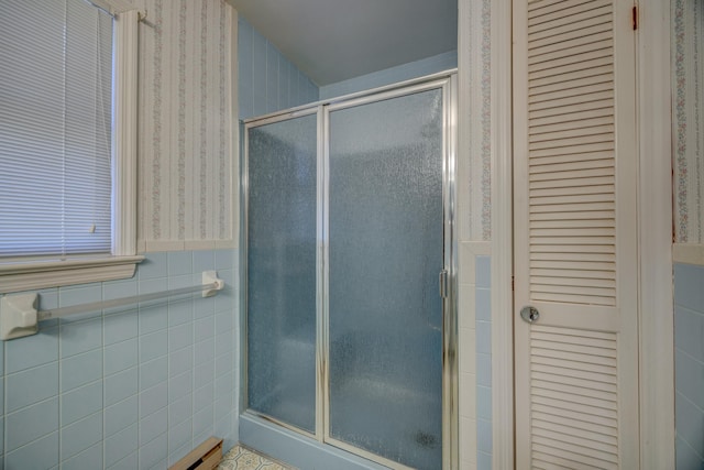 bathroom featuring tile walls and walk in shower