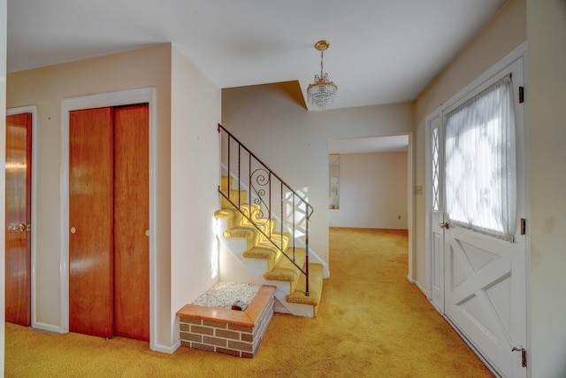 foyer featuring light colored carpet