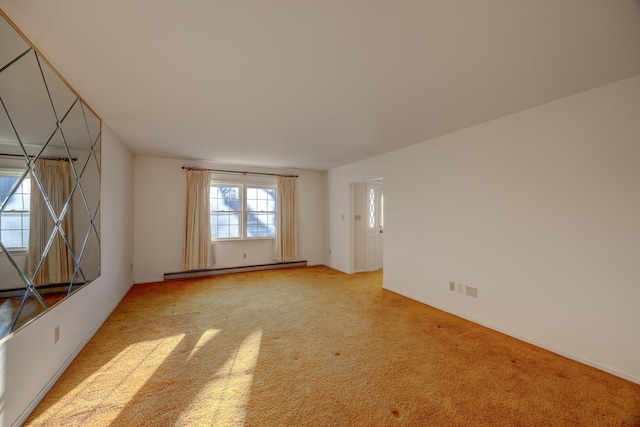 carpeted spare room featuring a baseboard radiator