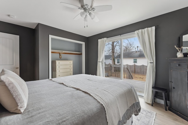 bedroom with access to outside, a closet, light wood-type flooring, and a ceiling fan