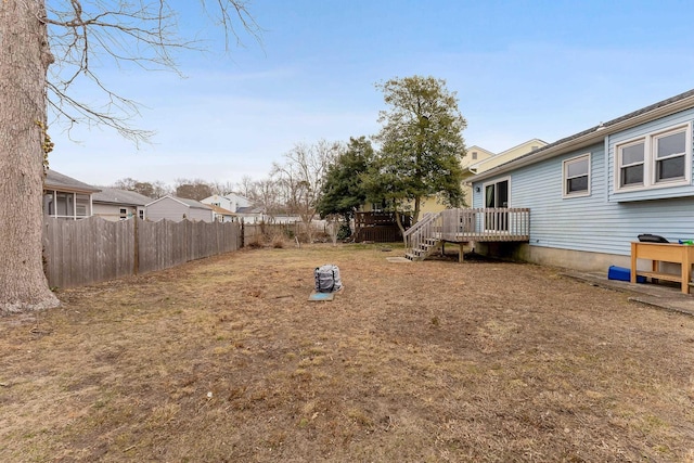 view of yard with a deck and fence