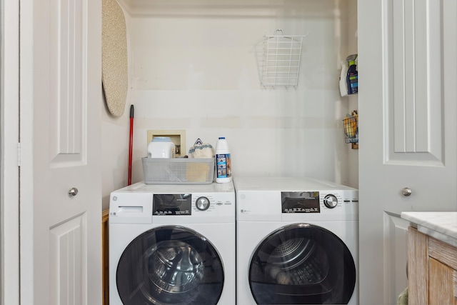 washroom featuring laundry area and washing machine and clothes dryer