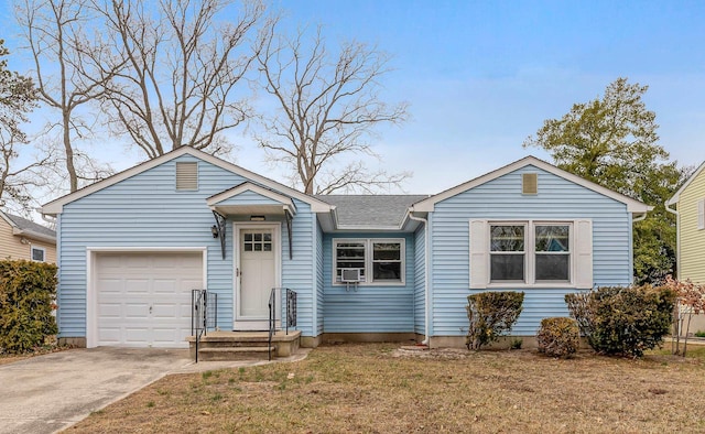 ranch-style house with a garage, a shingled roof, concrete driveway, and a front yard