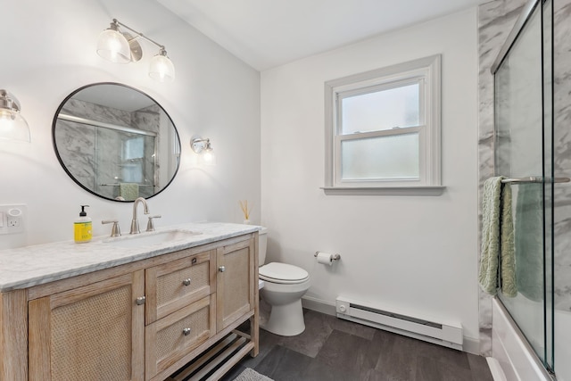 full bathroom with bath / shower combo with glass door, a baseboard radiator, toilet, vanity, and baseboards