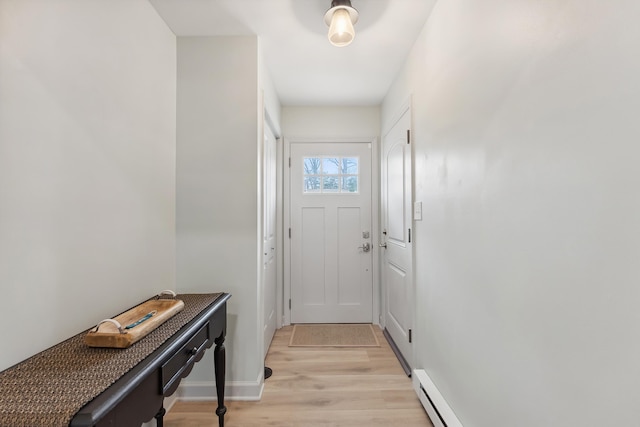 entryway featuring light wood-type flooring, a baseboard radiator, and baseboards