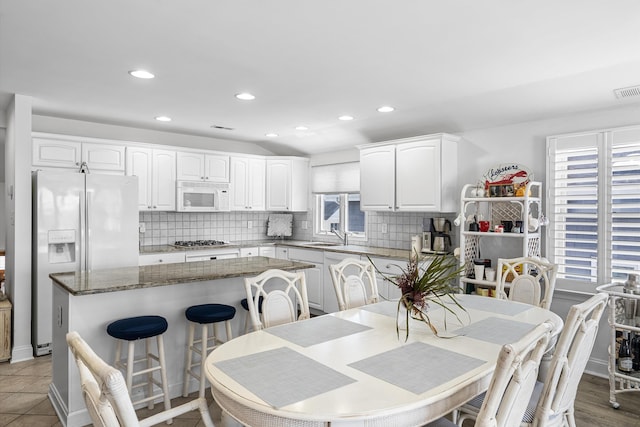 3328 Ocean Dr Unit 3328, Avalon, NJ 08202 - kitchen featuring white appliances, a kitchen island, decorative backsplash, white cabinets, and recessed lighting