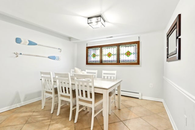 dining room with light tile patterned floors, baseboards, and a baseboard radiator