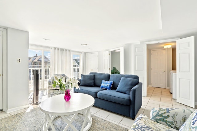 living room featuring light tile patterned floors and baseboards