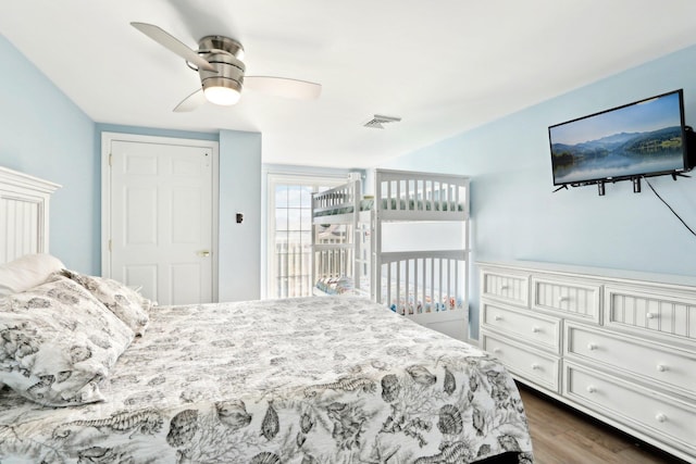 bedroom featuring visible vents, a ceiling fan, and dark wood-type flooring