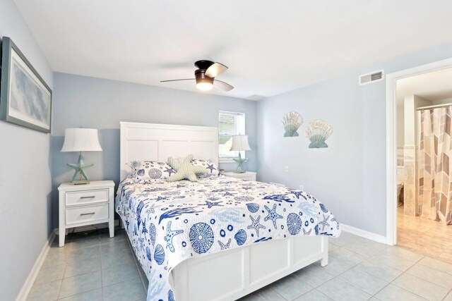 bedroom with light tile patterned floors, visible vents, a ceiling fan, and baseboards