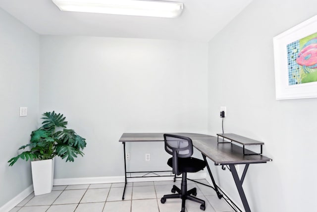 office space with light tile patterned floors and baseboards