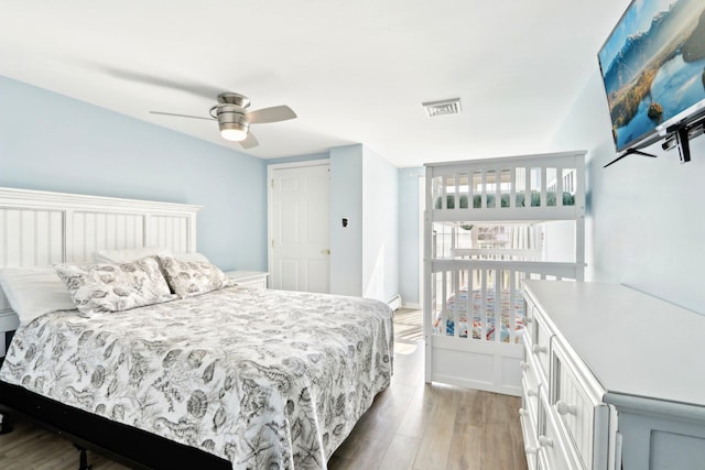 bedroom featuring visible vents, a ceiling fan, and light wood-type flooring