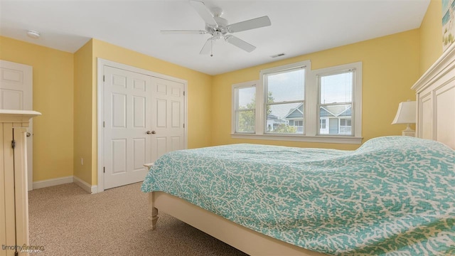 carpeted bedroom with a closet and ceiling fan