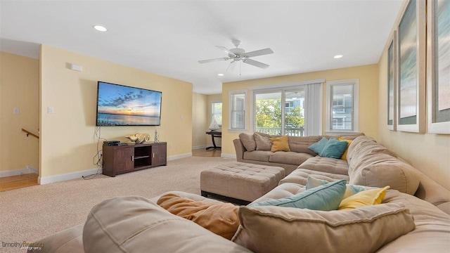 carpeted living room featuring ceiling fan