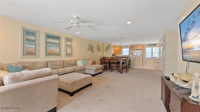 carpeted living room with ceiling fan