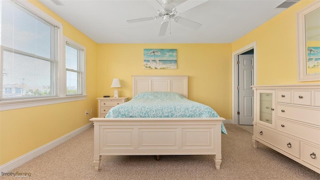 bedroom featuring light carpet and ceiling fan