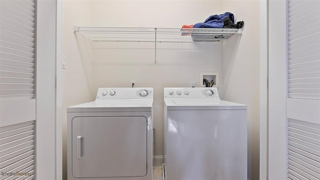 clothes washing area featuring washer and clothes dryer