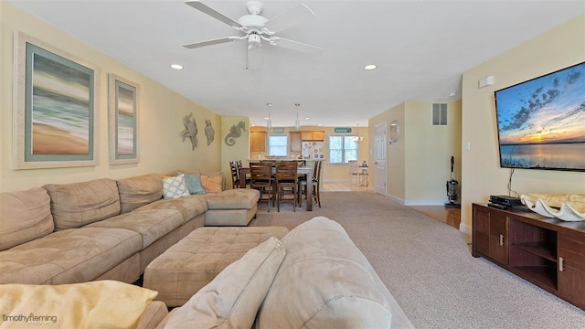 carpeted living room featuring ceiling fan