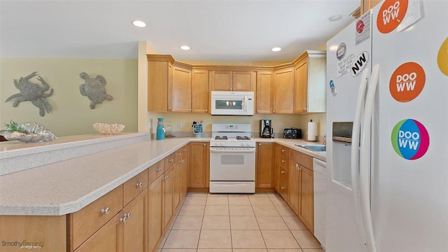 kitchen featuring sink, white appliances, kitchen peninsula, and light tile patterned floors