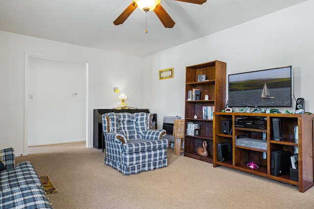 sitting room with light colored carpet and ceiling fan