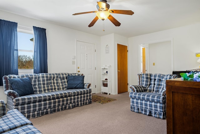 carpeted living room with ceiling fan