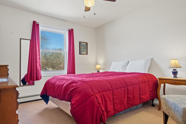 carpeted bedroom with ceiling fan and baseboard heating