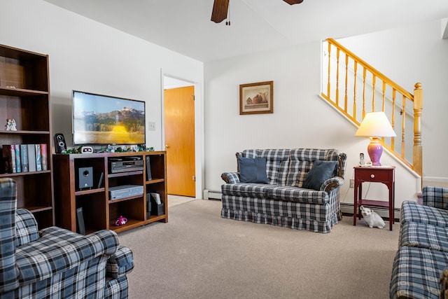 carpeted living room with ceiling fan and a baseboard heating unit