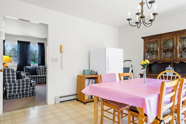 dining space featuring a baseboard radiator and a notable chandelier