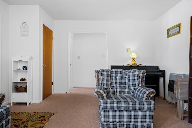 sitting room featuring carpet flooring and heating unit