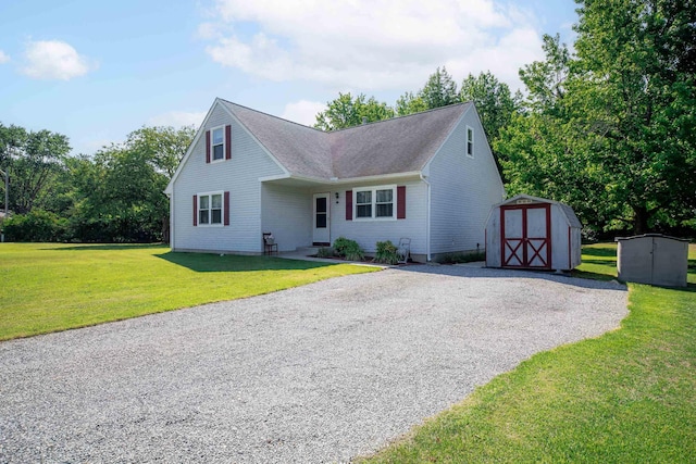 view of front facade featuring a front yard and a shed