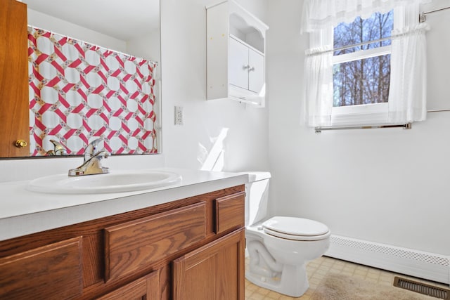 bathroom with vanity, a baseboard radiator, and toilet