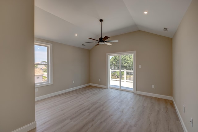 empty room featuring light wood-type flooring, ceiling fan, and lofted ceiling