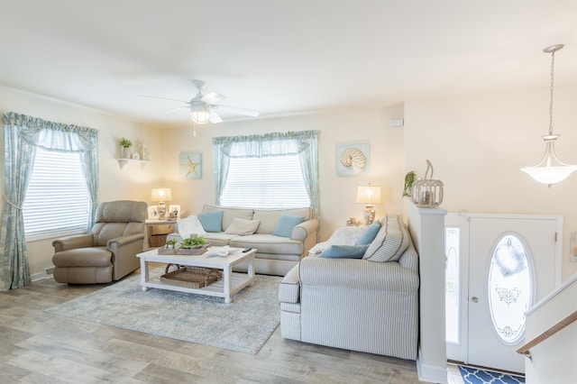 living room featuring wood-type flooring and ceiling fan