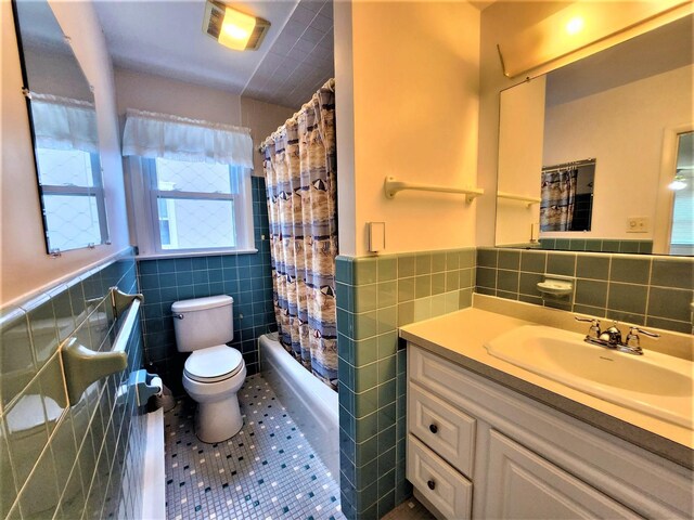 9903 2nd Ave, Stone Harbor, NJ 08247 - full bath featuring tile walls, tile patterned flooring, toilet, vanity, and wainscoting
