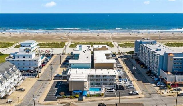 drone / aerial view featuring a water view and a beach view