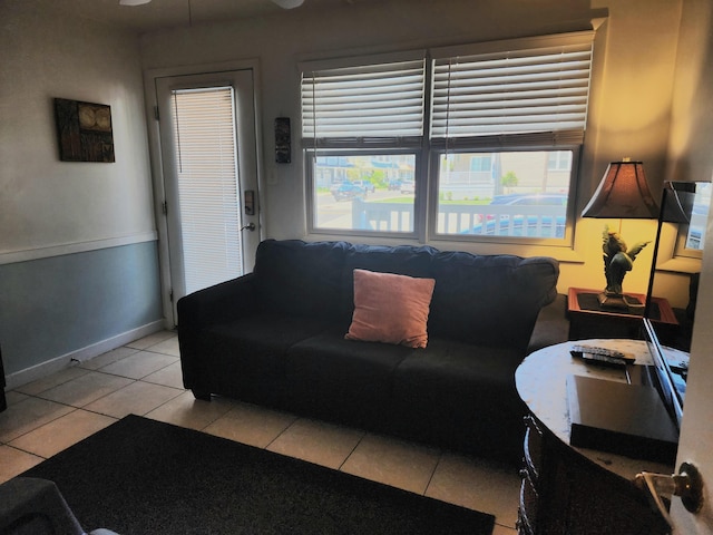 living room featuring ceiling fan and light tile patterned flooring