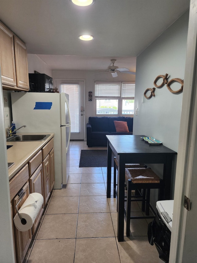 kitchen with ceiling fan, sink, and light tile patterned flooring